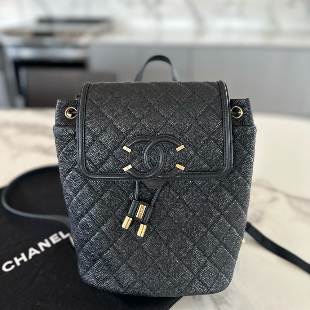 Chanel black caviar filigree backpack with matte gold hardware